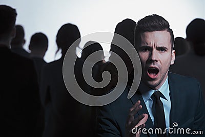 Businessman screaming in a crowd Stock Photo