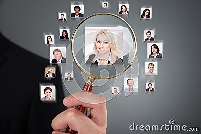 Businessman searching candidate with magnifying glass Stock Photo