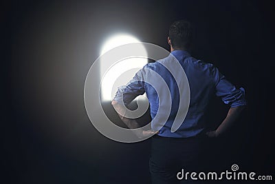 Businessman sees the light at the end of the tunnel Stock Photo