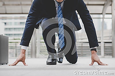 Businessman set in start running position prepare to fight in business race Stock Photo