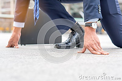 Businessman set in start running position prepare to fight in business race Stock Photo