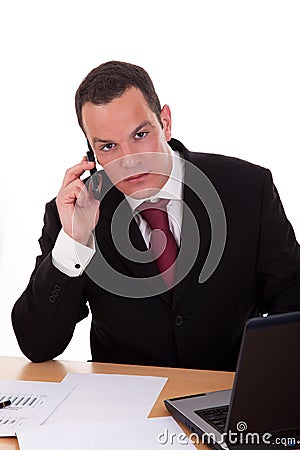 Businessman setting a desk talking on the phone Stock Photo