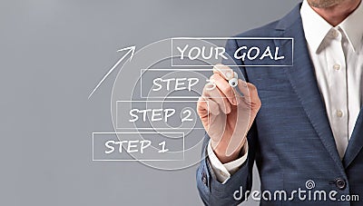 Businessman Setting Goal Writing Steps To Achieve Success, Gray Background Stock Photo