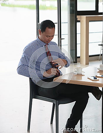 Businessman setting necktie Stock Photo