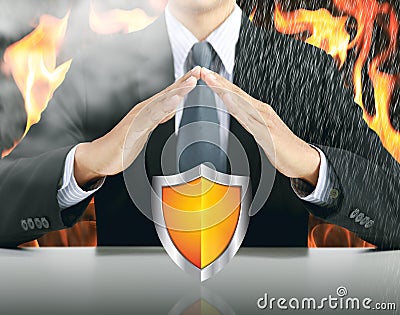 Businessman and shield with fire background Stock Photo