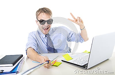 Businessman in shirt and tie sitting at office computer desk holding selfie stick shooting self portrait photo Stock Photo