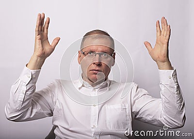 Businessman show smth with both hands in surprise and shock Stock Photo