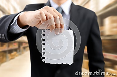 Businessman show task list on notepad with warehouse background Stock Photo