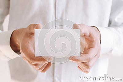 Businessman showing a blank piece of paper. Businessman in white shirt giving business card Stock Photo