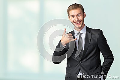 Businessman showing Call me sign Stock Photo