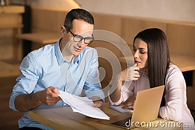 Businessman showing documents to businesswoman Stock Photo