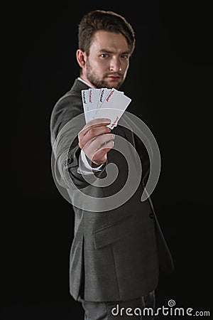 Businessman showing Joker cards isolated on black Stock Photo