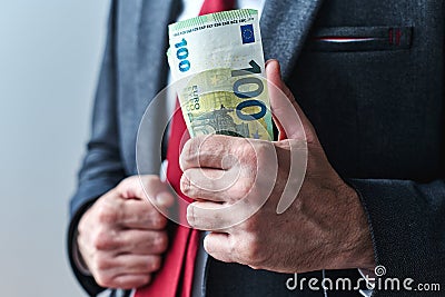 Businessman showing off with money, swagger entrepreneur holding bunch of hundred euro banknotes Stock Photo