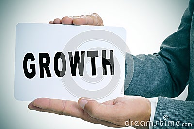 Businessman showing a signboard with the text growth Stock Photo