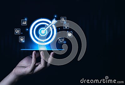 Businessman showing target arrow virtual digital technology icon on board, business investment concept, objectives and goals Stock Photo