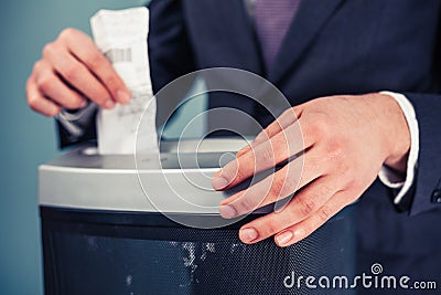 Businessman shredding documents Stock Photo