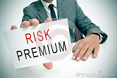 Businessman with a signboard with the text risk premium Stock Photo