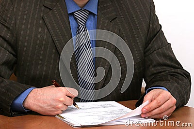 Businessman is signing a document Stock Photo