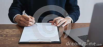 Businessman signing financial contract and hand holding pen putting signature after reaching agreement. Stock Photo