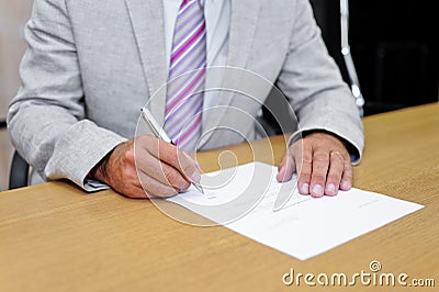 Businessman signing a paper form Stock Photo