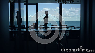 Businessman silhouette enjoying break in conference room. Manager going at pause Stock Photo