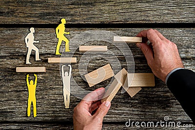 Businessman with silhouette people helping others climbing wooden stairs Stock Photo