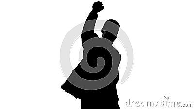 Businessman silhouette raises fist up, celebrates success, proud of achievement Stock Photo