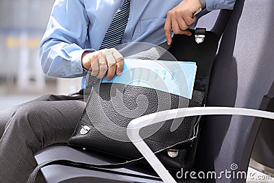 Businessman siting on a chair and geting out documents with gr Stock Photo