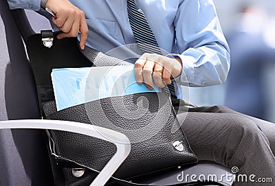 Businessman siting on a chair and geting out documents with gr Stock Photo