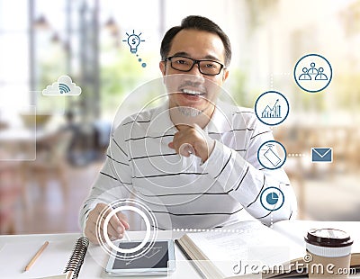 Businessman sitting in the coffee shop and writing on a digital tablet. Many people are able to study or work in various places Stock Photo