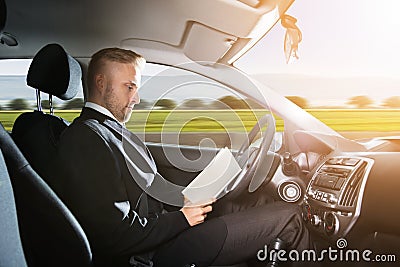 Businessman Sitting Inside Self Driving Car Stock Photo