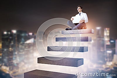 Businessman sitting on stairs in night city sky Stock Photo