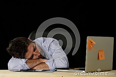 Businessman sleeping wasted and tired at office computer desk in long hours of work Stock Photo