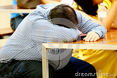 Businessman sleeps on desk after Tired overworked Stock Photo