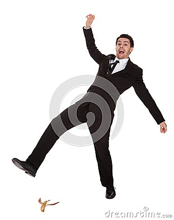 Businessman slipping on banana peel Stock Photo