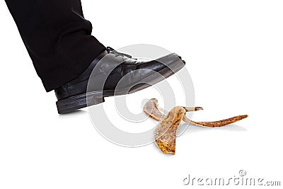 Businessman slipping on banana peel Stock Photo