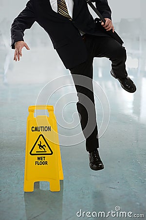 Businessman Slipping on Wet Floor Stock Photo