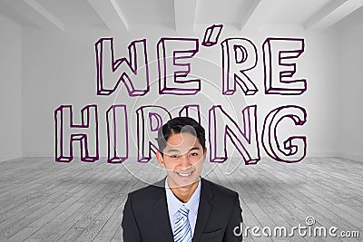 Businessman smiling in front of were hiring text Stock Photo