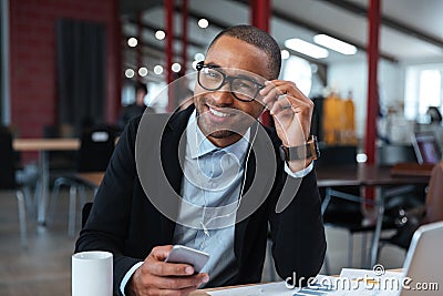 Businessman smiling and touching his glasses Stock Photo