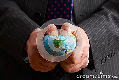 Businessman Squeezing Globe Over North America Stock Photo