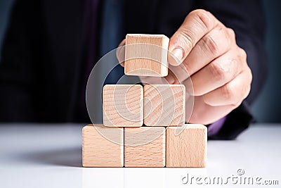 Businessman Stack Wooden Pyramid Stock Photo