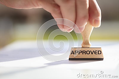 Businessman stamping approved stamp on document in meeting Stock Photo