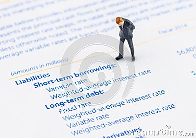 Businessman stand on the balance sheet Stock Photo