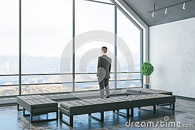 Businessman standinf in cozy attic interior room Stock Photo