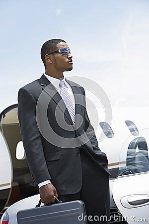 Businessman Standing With Attitude At Airfield Stock Photo