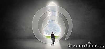 Businessman standing in a big keyhole Stock Photo