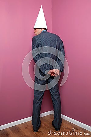 Businessman standing in the corner Stock Photo