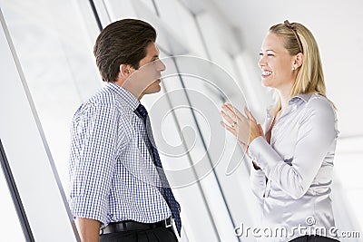 Businessman standing in corridor talking Stock Photo