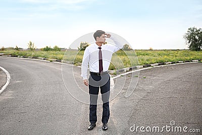 Businessman standing at crossroads. Concept of choice Stock Photo