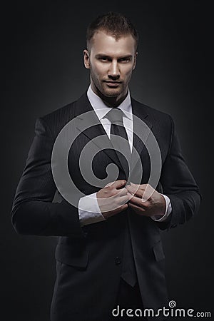 Businessman standing on dark background Stock Photo